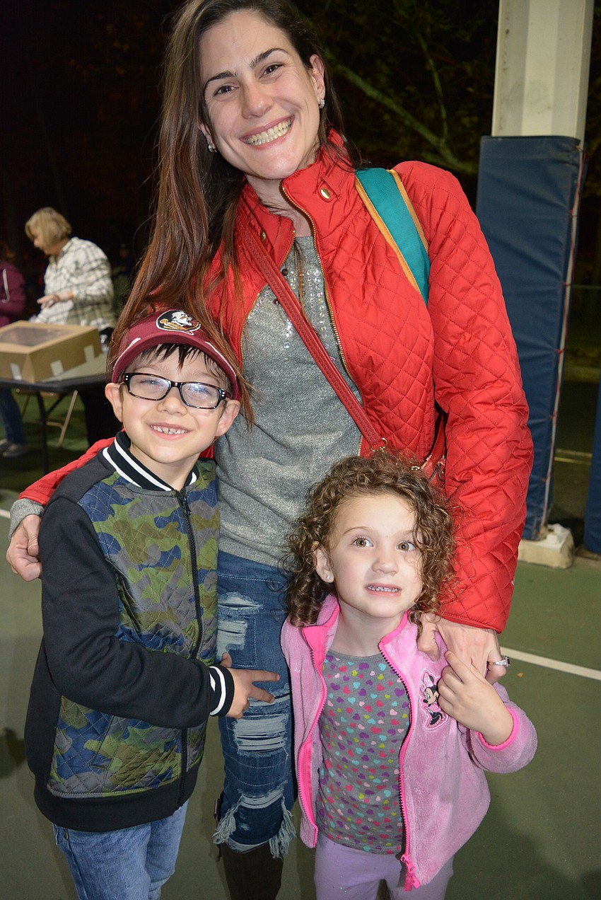 Alessandro, Annya and Arianna Hernandez buy their tickets and are ready to eat and play.