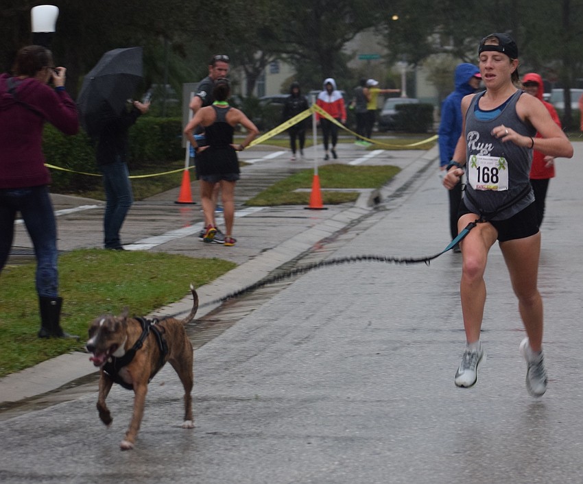 Sarasota's Sandra Houseweart finishes the race with her rescue dog Primrose. 
