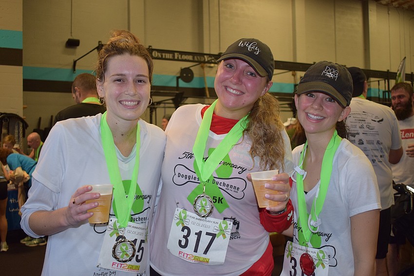 Sarasota's Shelby Duke, Julia Stringer and Sabrina Charlotte show off their medals. This is Stringer's second 5K of the year. She wants to run 12 5Ks in 2020.