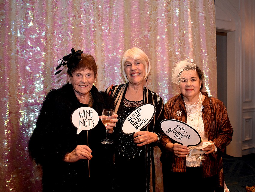 Millie Finkel, Judy Rosemarin and Patty Bjelland have fun at the photo booth during cocktail hour.