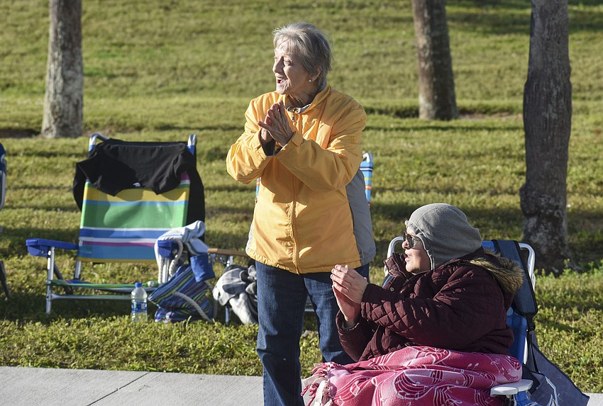 Bertha Moyer and Wanda Geiger cheer on the runners as they pass.