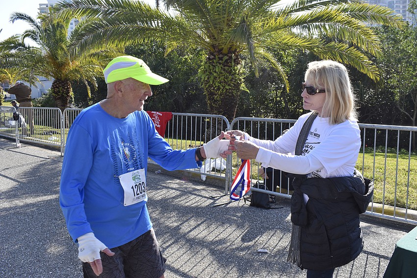 Chuck Van Duzee, 82, accpts his medal from Joan Hazen.