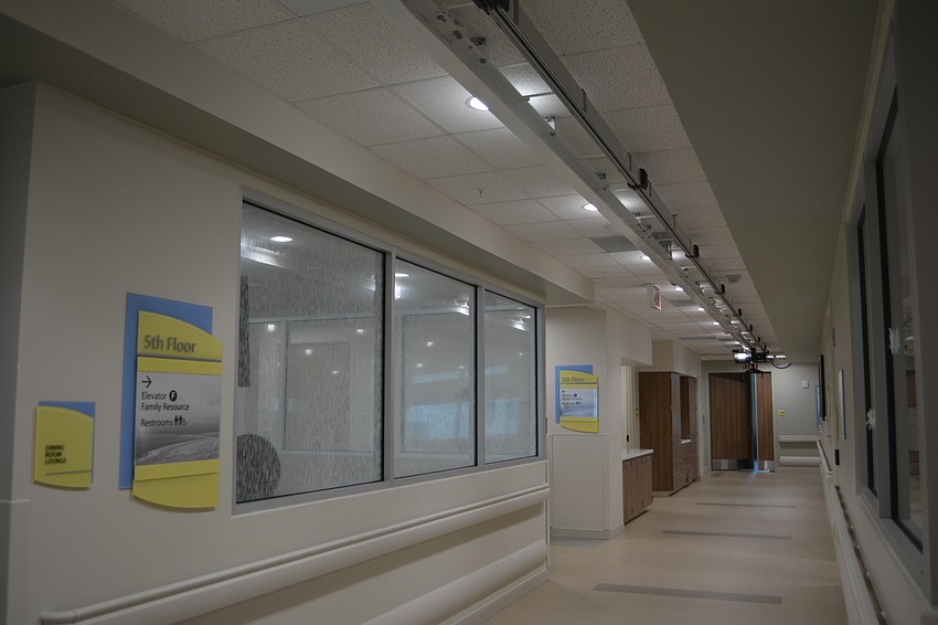 Patients strap into the Bioness Vector, on the ceiling, to practice walking and falling safely without the stress of their full body weight. The tinted squares on the floor help patients mark the distance they've traveled.