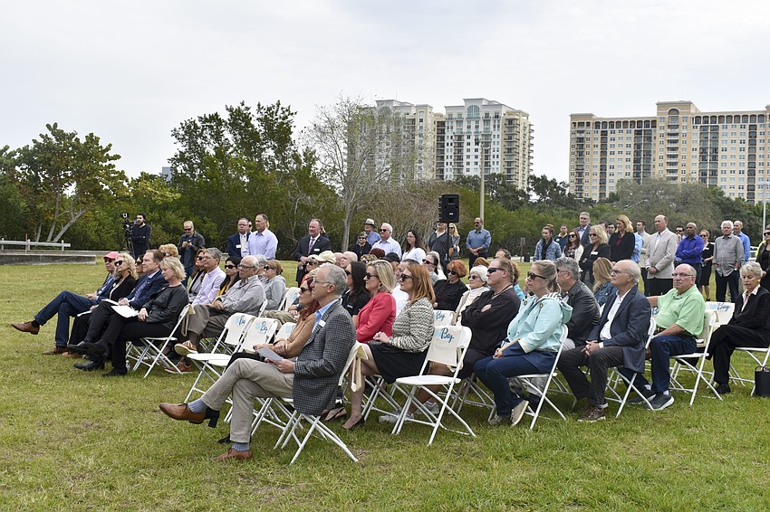 Community members join in watching the groundbreaking for the mangrove bayou walkway.