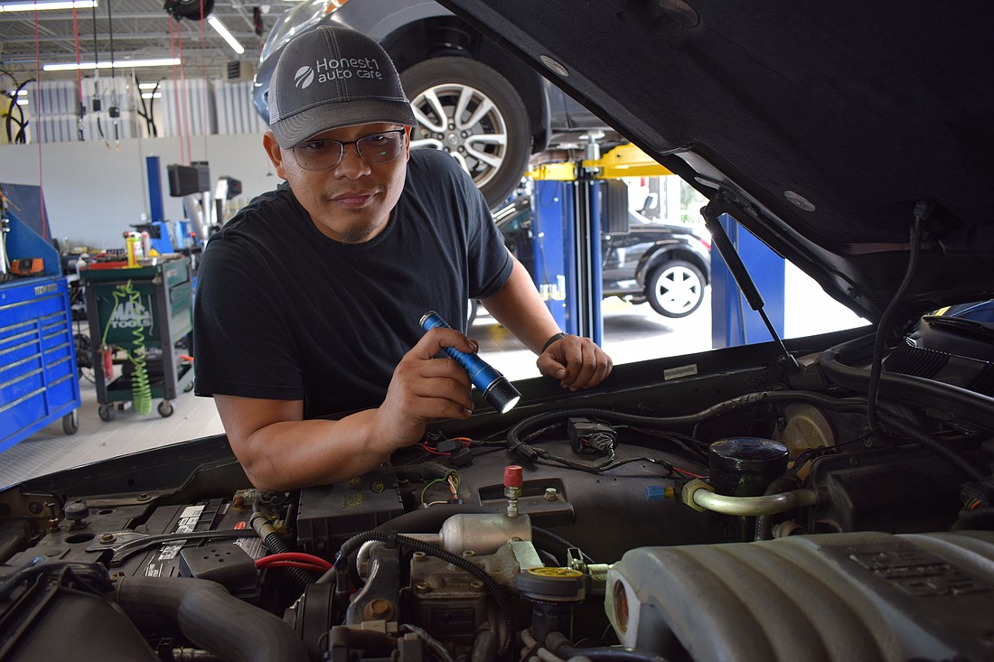 Sarasota mechanic Robert Phothisack works on a car at Honest1 in Lakewood Ranch.