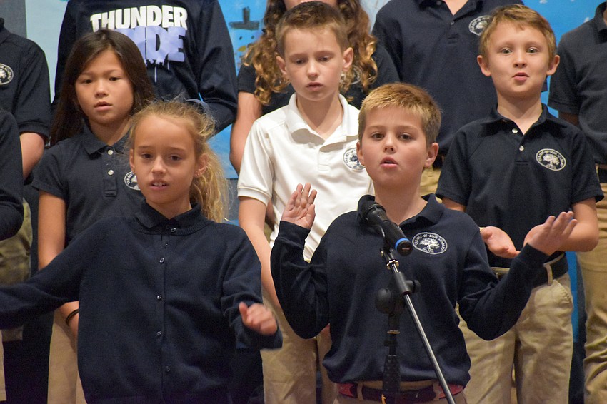 Third grade students Lila Lavezzoli and Dillon O’Callaghan sing during an assembly.