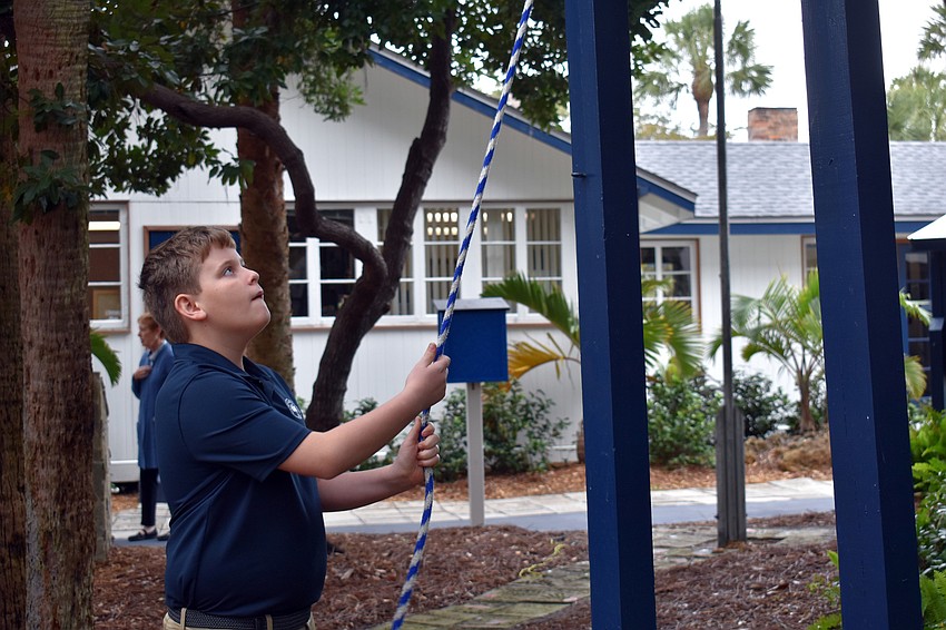 Fourth grader Jackson Chepak is one of 95 people to ring the campus bell.