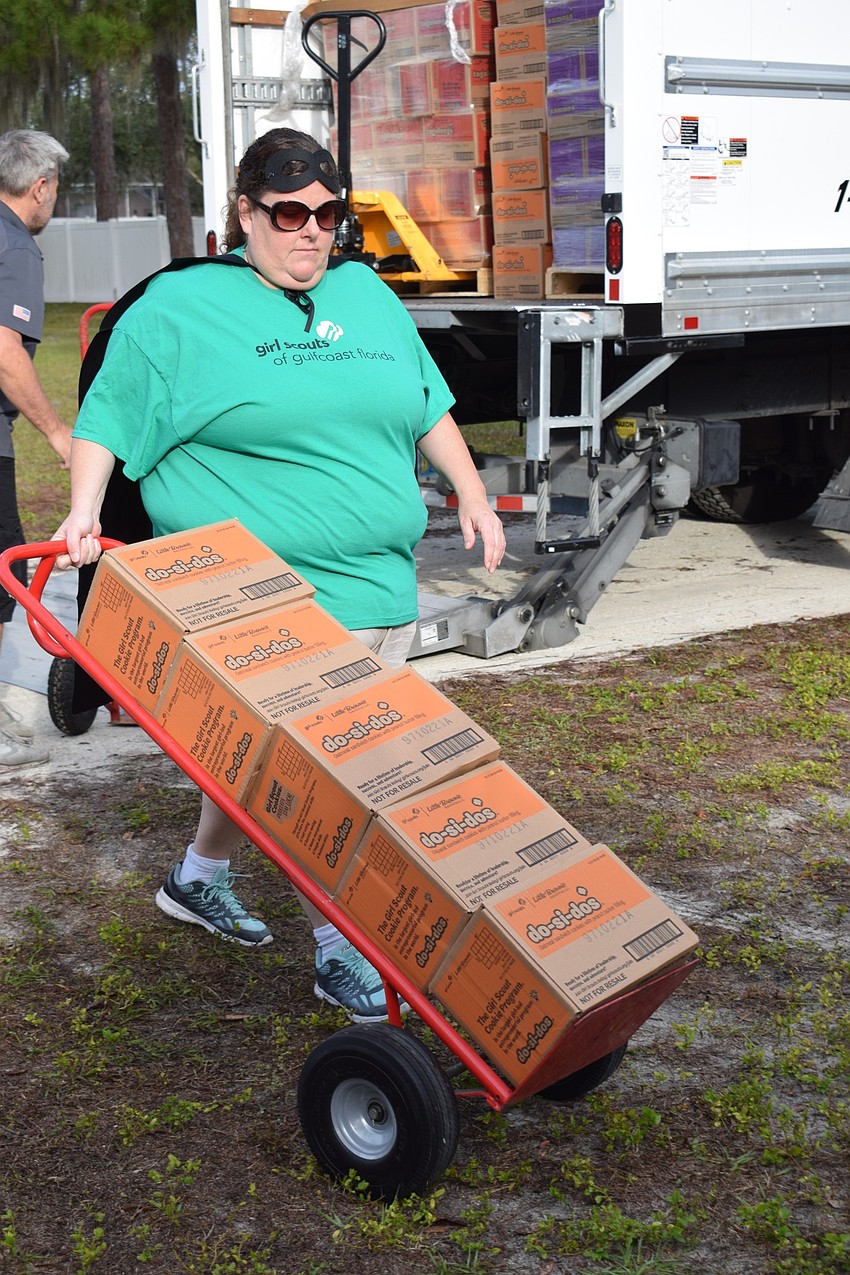 Erika Rolando, service unit manager, rolls in five cases of Do-si-dos.