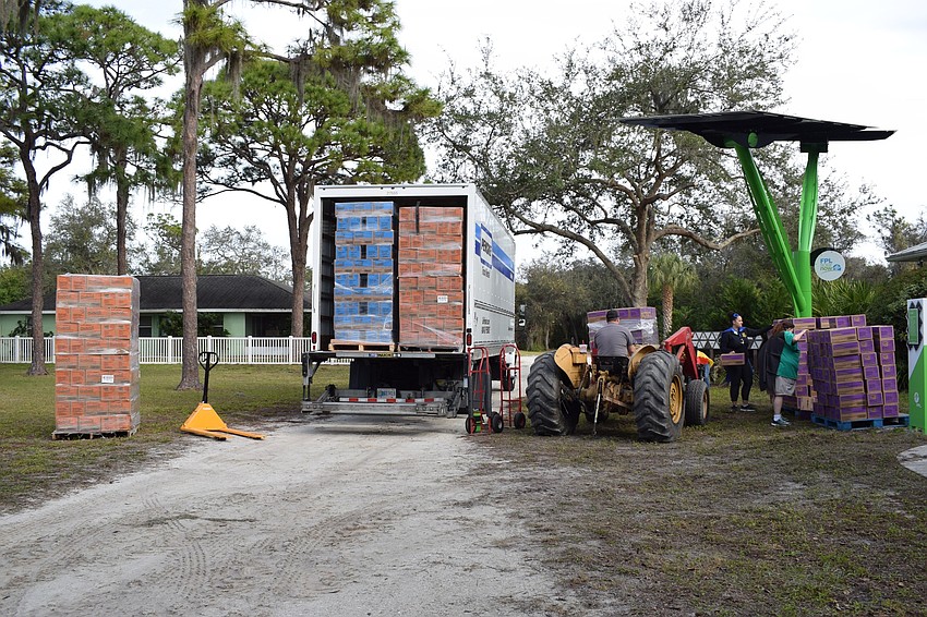 Thousands of cookies are unloaded from a truck to be distributed to Girl Scout troop leaders.