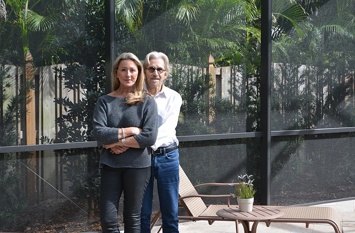 Sally Fernandez (left) and her husband/editor, Joe Fernandez, stand in their "conference room" by the pool at their Sarasota home.