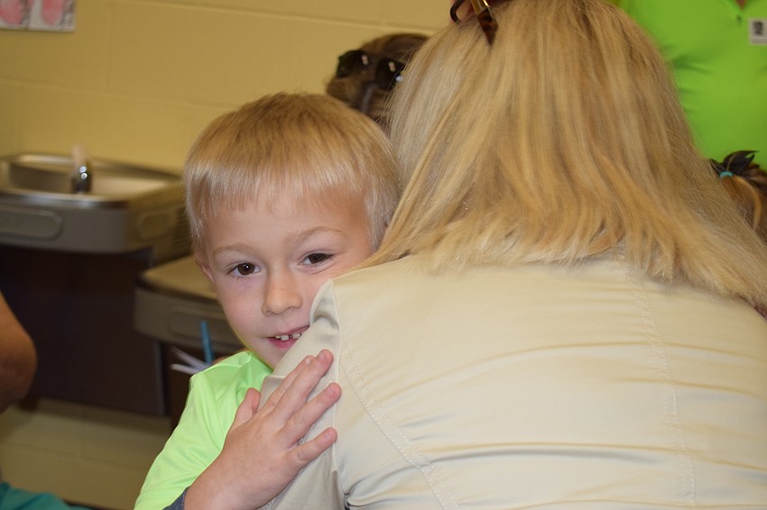 Liam Skelly, a kindergartner, hugs his grandmother Deborah Skelly when he sees her at Grandparents Day.