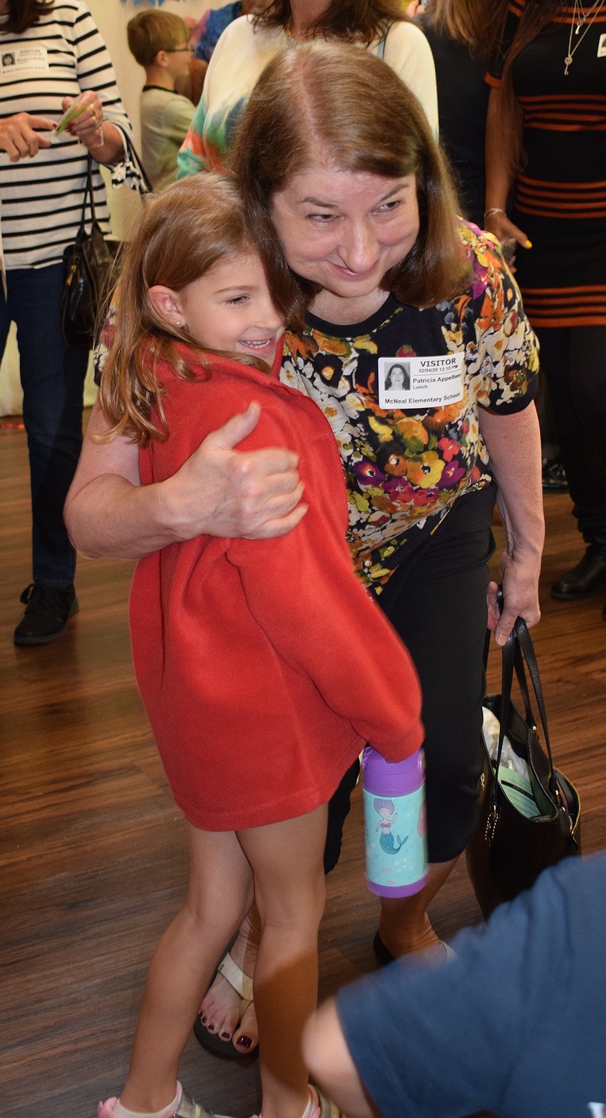 Adelyn Layne, a kindergartner, hugs her grandmother Patricia Appelbee before going to eat lunch together.