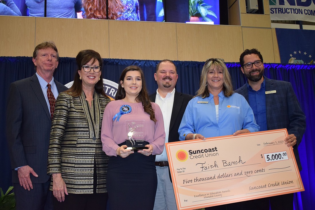 Faith Bench, a math teacher at Braden River Middle School, received an award and check for being Educator of the Year.