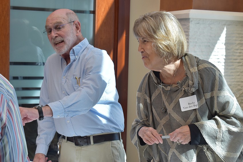 Andy Maass and Becky Van Der Bogert welcome attendees to the meeting.