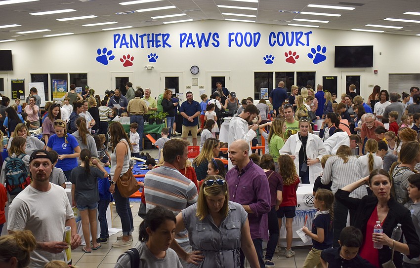 Students and their families pack the cafeteria for STEM night.
