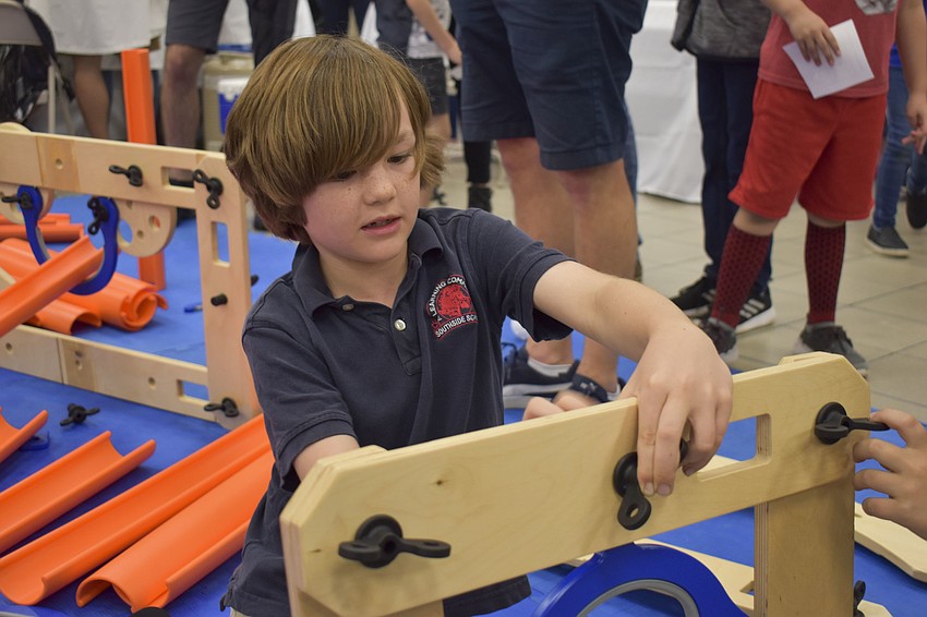 Cru Raines, 8, finds a matching piece for his Rigamajig.