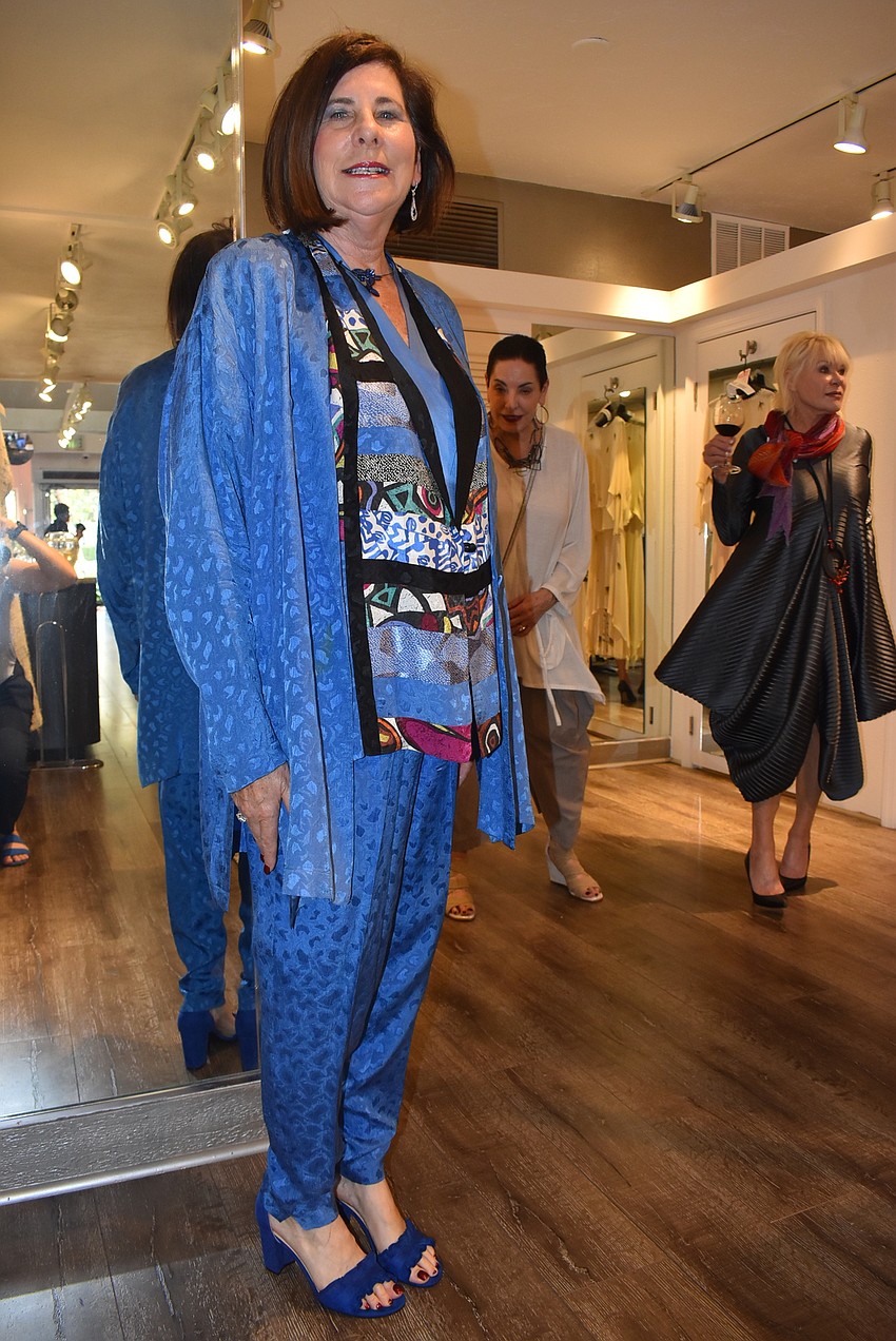 Rebecca Sachs wears a blue silk suit from 1990.