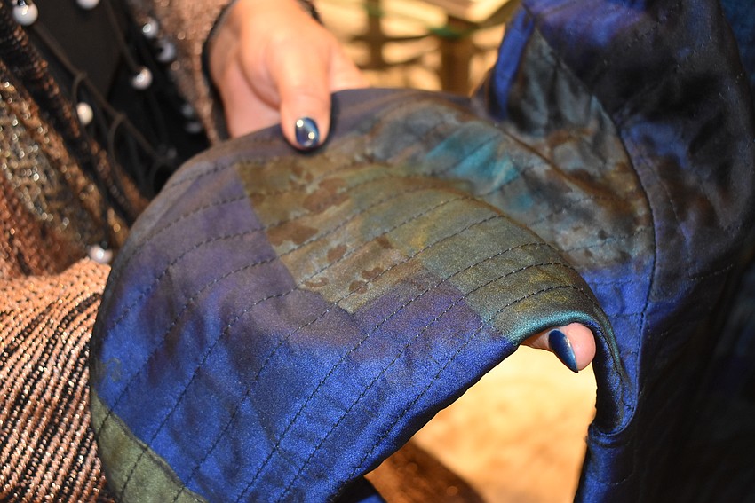 Joan Morgan shows off a hand-painted, hand-stitched coat.