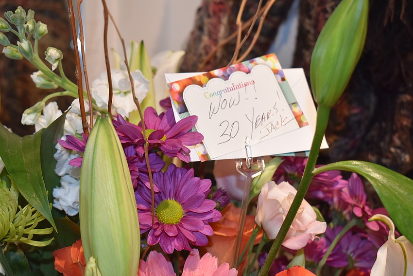 Congratulatory flowers near the champagne and snacks