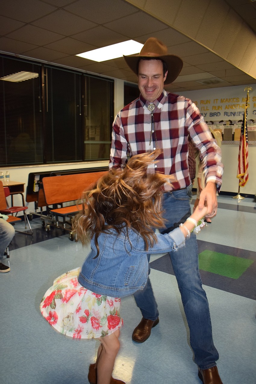 Patrick Foley dances with his daughter, Grace, who is in kindergarten, to 