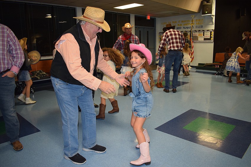 Kevin Kelly dances with his granddaughter Scarlett Giuliano, a first grader. Giuliano was also accompanied by her father, Bryan Giuliano.
