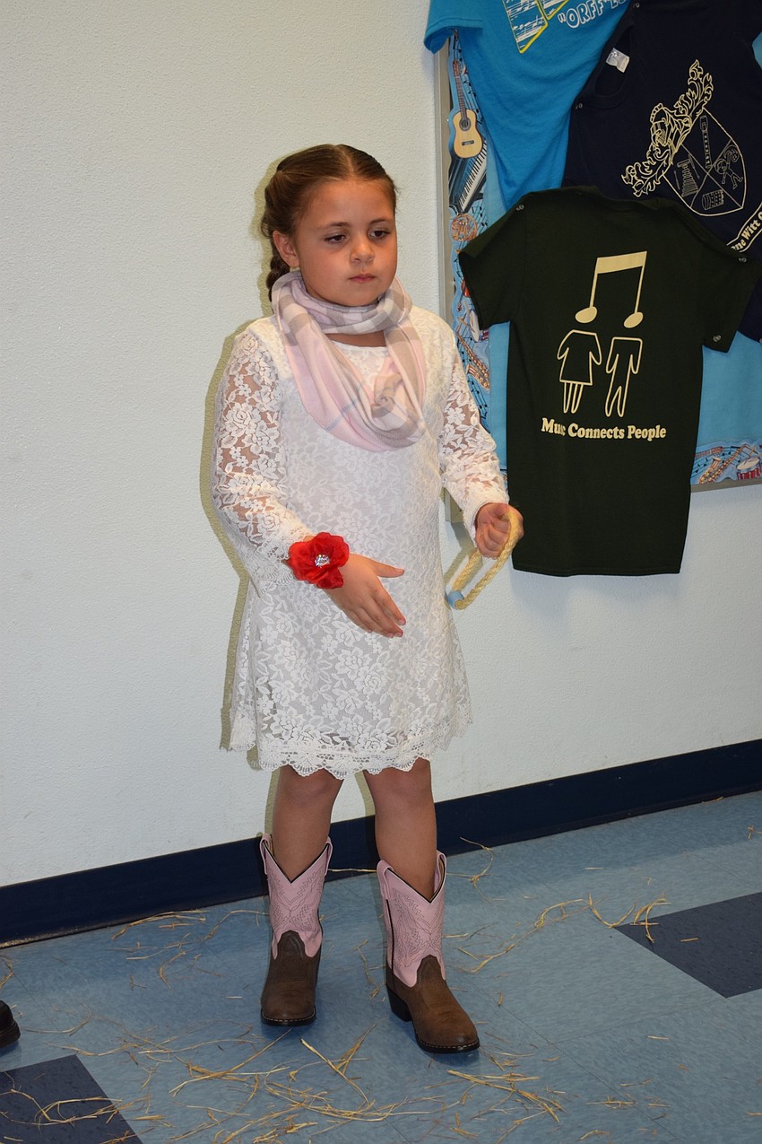 Alivia Patterson, a first grader, tries her best to throw a ring onto a cactus.
