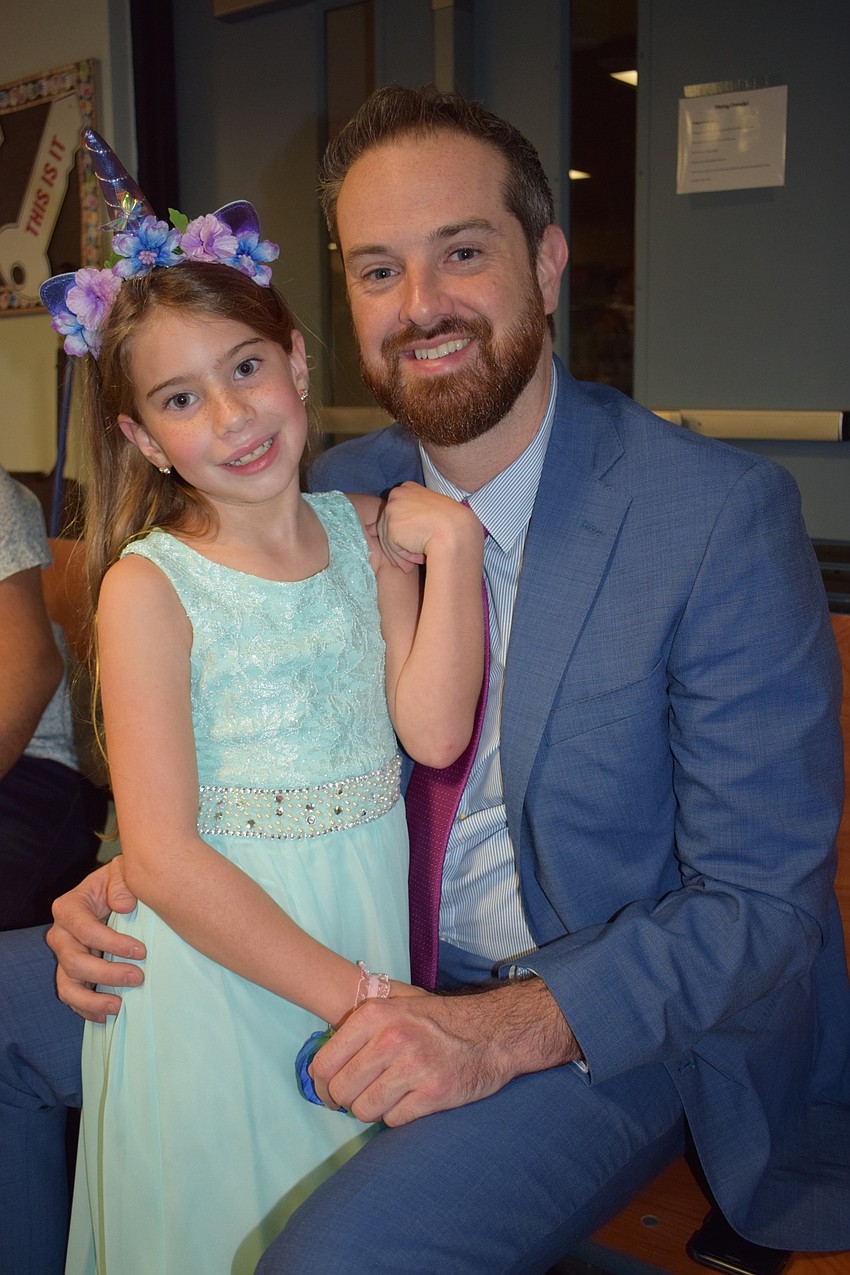 Scarlett Weinkiper, a second grader, loves dancing with her friends and being with her dad, David, at the dance.