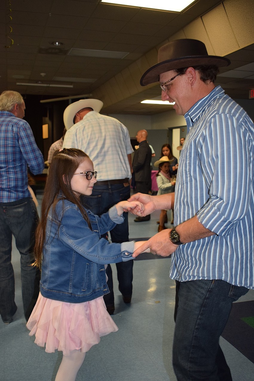 Ilyria Sutton, a third grader, slow dances with her father, Keith. Keith Sutton says the dance was a lot of fun.