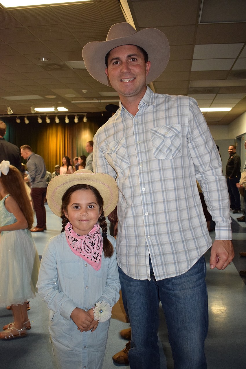 Nora Blasewitz, a first grader, and her dad, Michael, enjoy spending time together at the dance.
