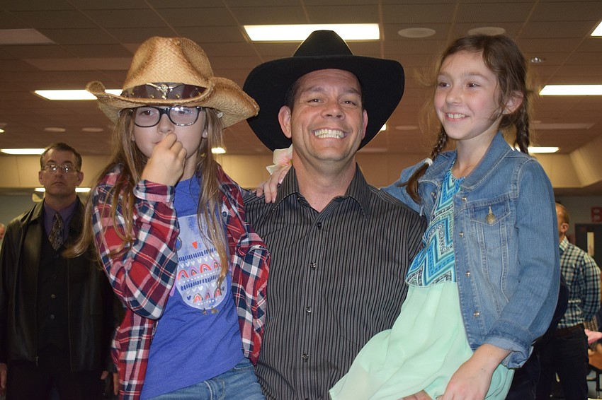 Paige, Emma and Jim Andersen dance together. Jim Andersen says it's exciting to have his two daughters, Emma, who is a fourth grader, and Paige, who is a third grader, at the dance with him.