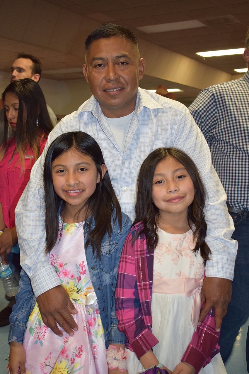 Bianco Gomez enjoys the dance with her father, Magdaleno Gomez, and her sister, Sherlyn Gomez, a first grader.