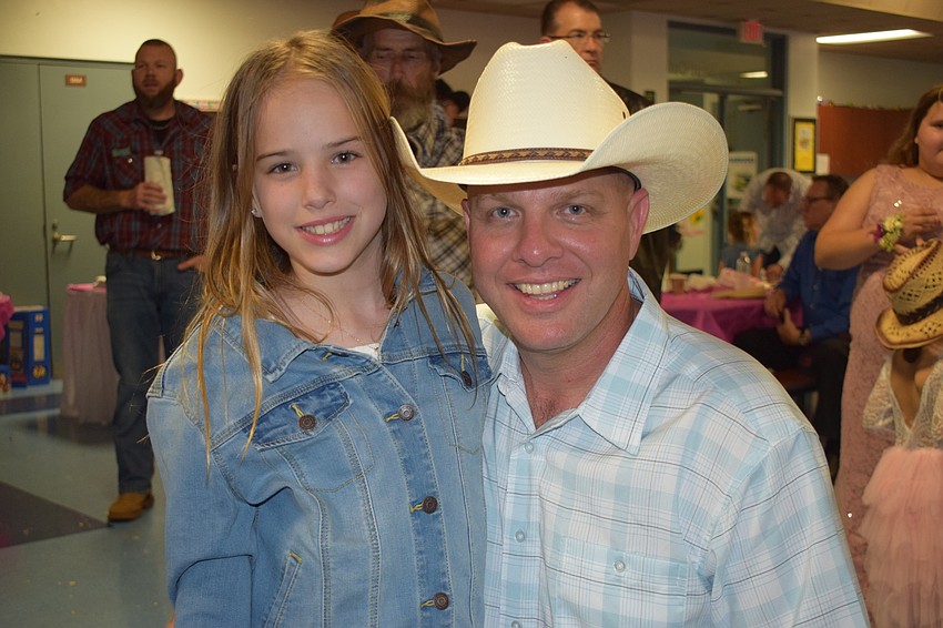 Alyssa Otterness, a fourth grader, dresses in a western theme with her father, David.