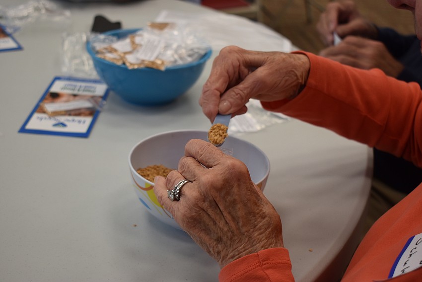 Dianne Schultz scoops tiny seeds.