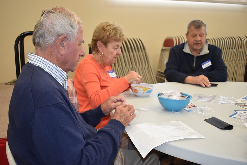 Don and Dianne Schultz pack seeds with Ken Bowes.