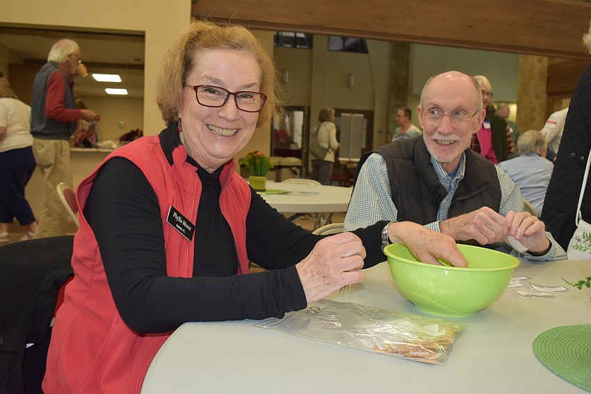Phyllis and Fred Moore are hard at work packing eggplant seeds.