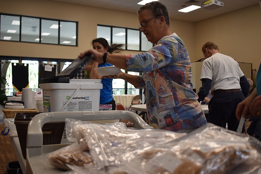 Ann Quackenbusch organizes seeds into tubs.