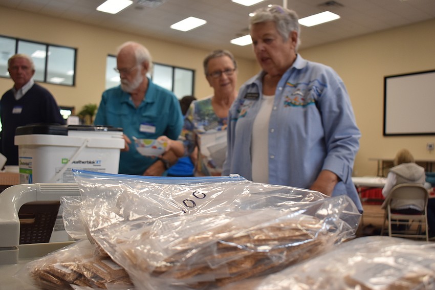 Members of Christ Church help count up the seed totals.