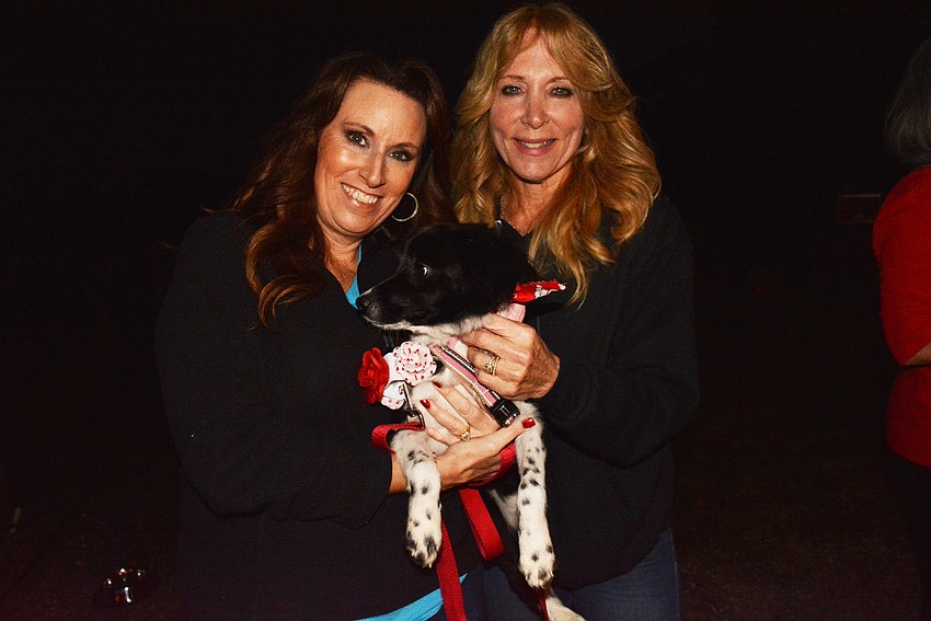 Lakewood Ranch's Christina Leider and University Park Country Club's Nanci Somers introduce guests to Willow, a dog up for adoption.