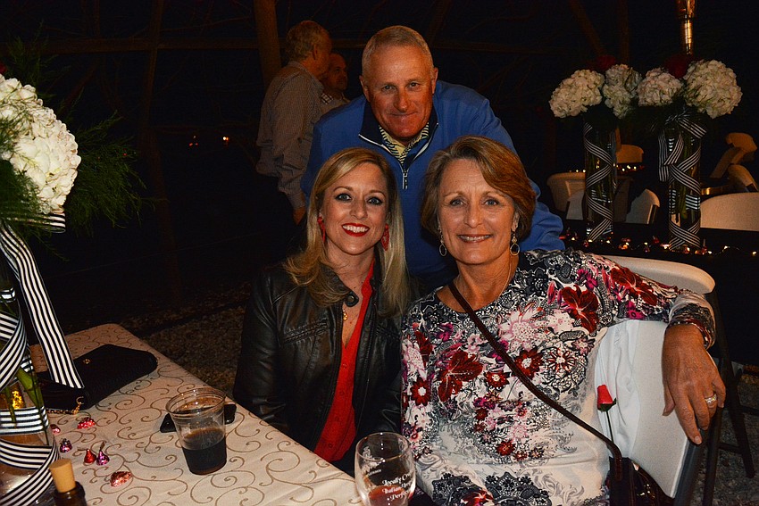 Lakewood Ranch's Michelle Falllis enjoys the night with her parents,  Rocky Burke (behind) and Barbie Burke (right), of Sarasota.