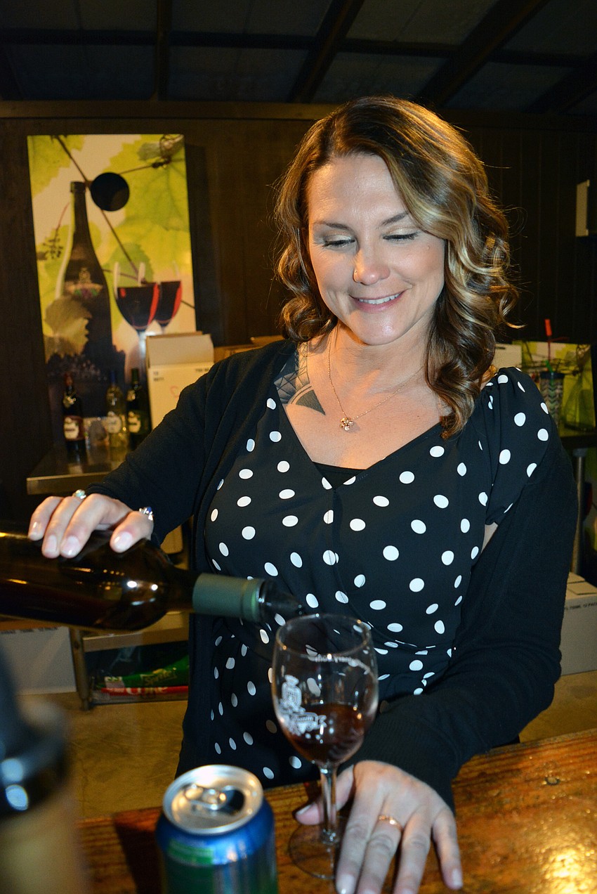 Christy Smith has fun pouring wine for the evening.
