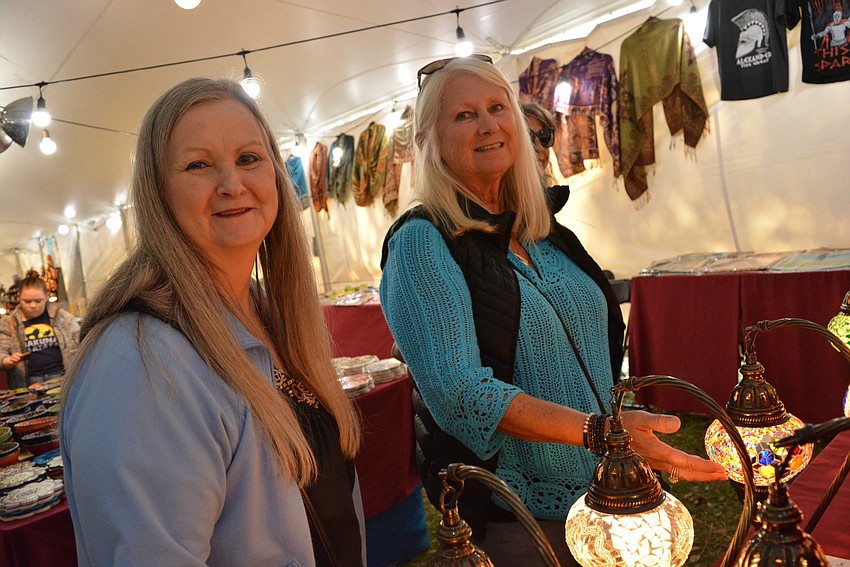 Virginia's Robin Broyles checks out handmade lamps with friend Paulette Brockhoff of Sarasota.