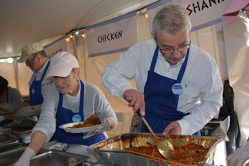 Barbara Briggs and Angelo Sifakes dish out lamb shanks.