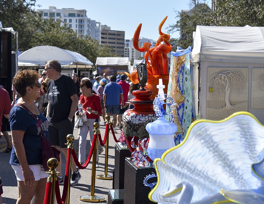Penny Letichevsky observes the glass sculptures.