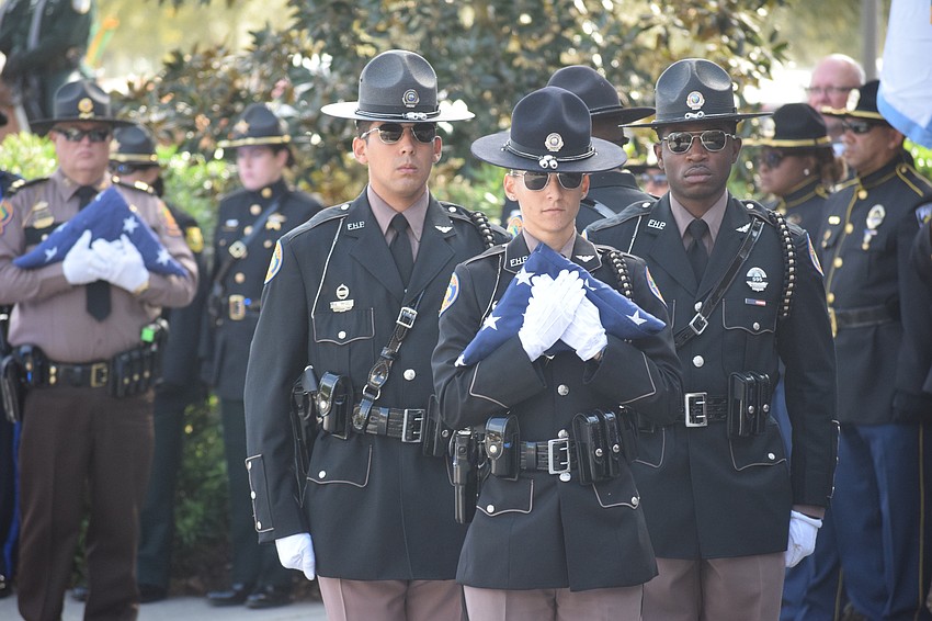 The flag being carried into the church is to be presented to the family of Trooper Joseph Bullock.