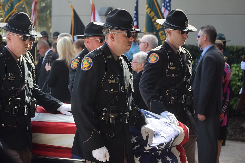 Pall bearers carry the casket of Trooper Joseph Bullock into the church.
