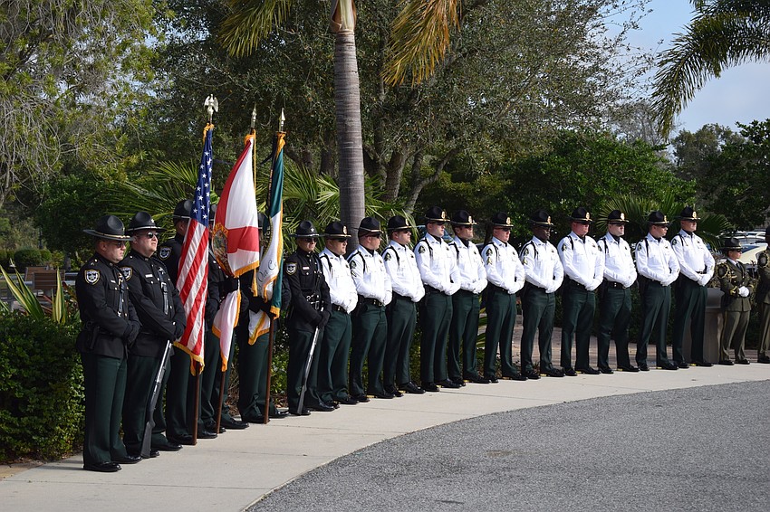 Law enforcement officers line the road leading to the front of Bayside Community Church.
