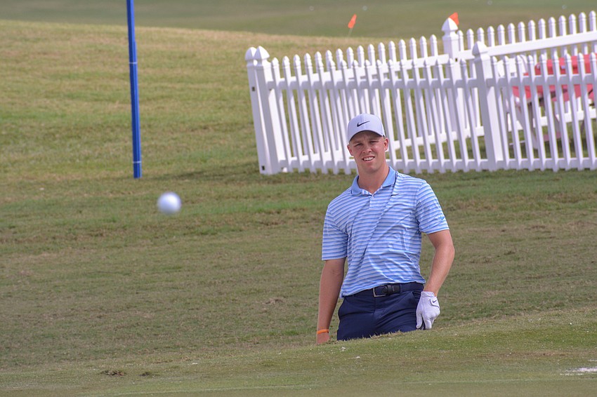 Nick Hardy watches his shot from the bunker on the No. 18 hole at Lakewood National hit the green. Hardy finished two under par on day one of the LECOM Suncoast Classic.