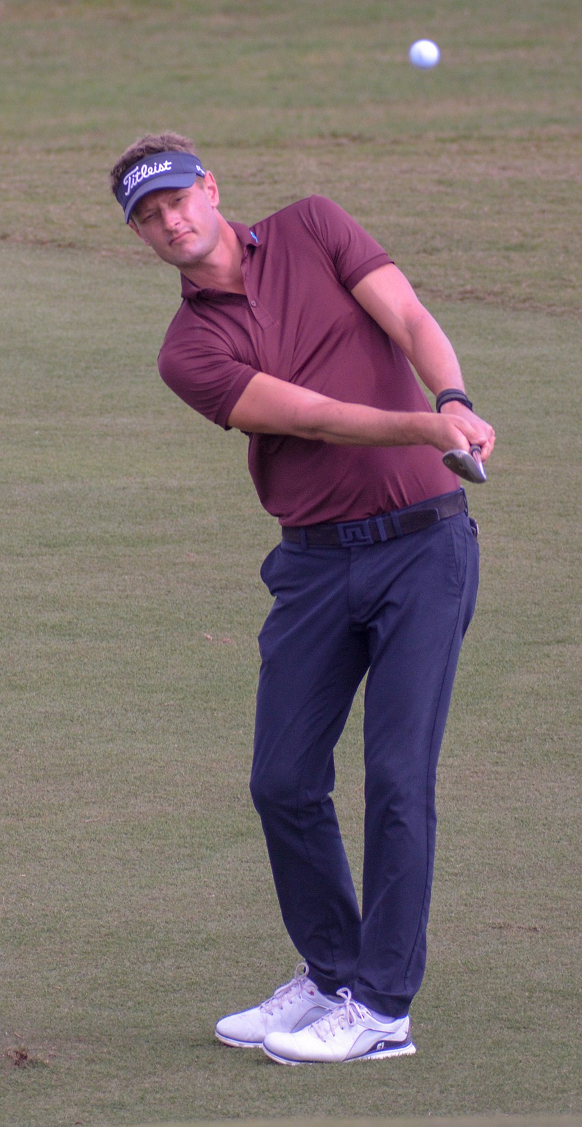 Blayne Barber chips his ball onto the green at No. 18. Barber finished five over par on the day.