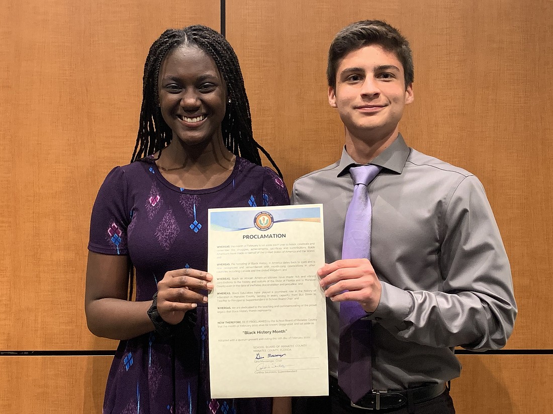 Laila Ward, an eighth grader at Mona Jain Middle School, and Nick Stanley, a senior at Lakewood Ranch High School, are given the School Board of Manatee County&#39;s Black History Month proclamation.