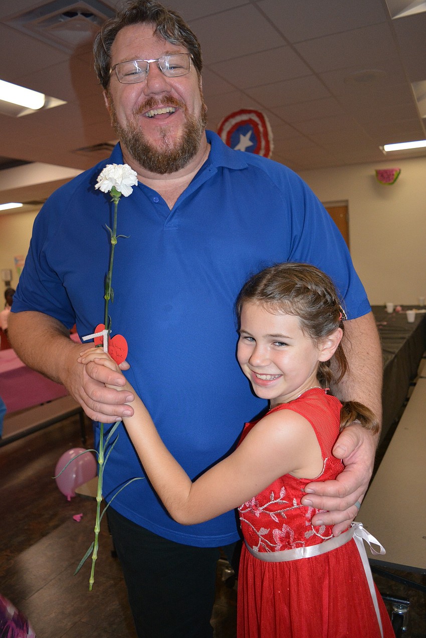 Jeff Hamlyn and his 9-year-old daughter, Molly, start their dancing between rows of tables in the cafeteria. 